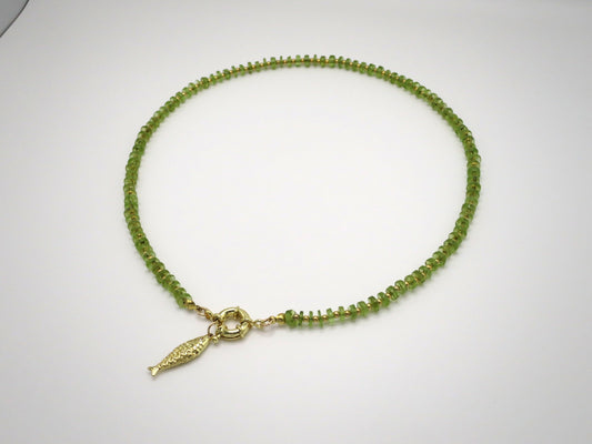 Green beaded necklace with a gold clasp on a white background
