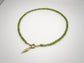 Green beaded necklace with a gold clasp on a white background